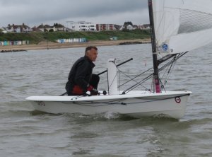 Under a grey sky John Tappenden heads out to sea in his RS Aero; going on to win the race
