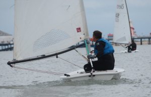 Trying to catch the leading boat, Ken Potts reaches towards the Pier in his Laser
