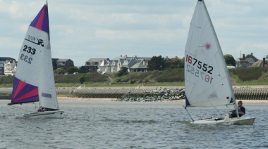 Beth Ford in her Laser pulls away from the Williams boys in their 405 during the Cadet Race