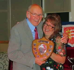 Veteran sailor Eddie White receives the Tarrant Trophy and a hug from Helen