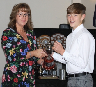 Cadet Vice Commodore Harrison Smith is presented with the Double G trophy as top Topper dinghy sailor