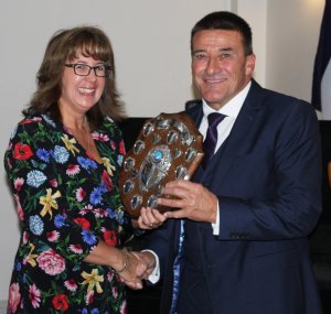 Ken Potts is presented with the Senior Leading Helm Trophy by Rear Commodore Helen Swinbourne