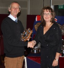 Club Treasurer Peter Downer receives his trophies from Rear Commodore Helen Swinbourne
