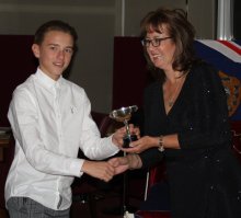 Harrison Smith is presented with the Stan Camp Progress Cup from Helen Swinbourne