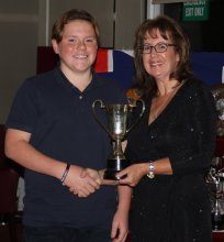 Cadet Alfie Searles is presented with the Remraf Merit Trophy by Helen Swinbourne for his positive contribution to the Club