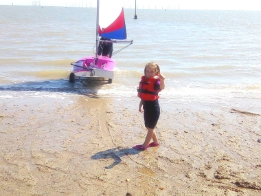 Five year old Club member Belle Hart gives the "thumbs-up" to getting on the water in her Topper "Ding Dong"