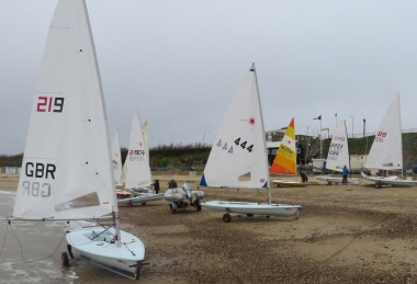 Under a somewhat overcast sky the competitors rig their boats