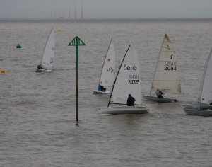 At the start of the race Tim Dye and Andy Dunnett bear down on starboard tack whilst John Tappenden manages to slip past on port
