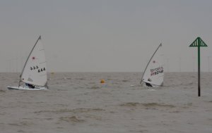 Andy Dunnett leads the Laser Radial start, with Paul Stanton on his heels