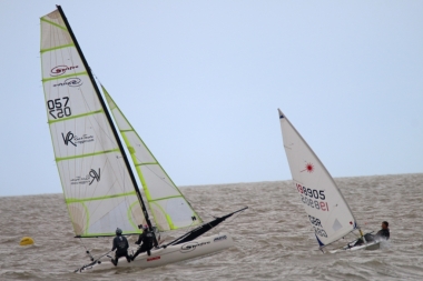 Little and Large - John Tappenden in his Laser is dwarfed by the Spitfire catamaran, sailed by James Stacey and Cat Elson