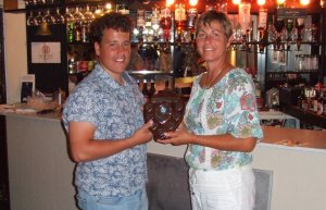 Cadet Commodore Harry receives the Long John Silver Trophy for victory in the menagerie fleet in his Laser