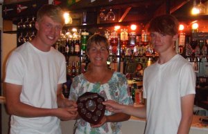 Claire congratulates Tom and Ed for winning the Captain Flint Shield for leading 405