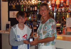 Cadet Office Claire presents the Swallows Trophy to Ted for being the Top Topper Sailor of the week