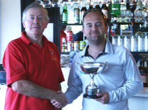 Nathan Batchelor from Tynemouth Sailing Club is presented with the Solution National Championship Trophy by Gunfleet's Malcolm Jolly