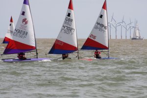 Alfie Searles leads the Topper fleet away from the start line, with Harry Swinbourne second and Jess McLean-Wright third