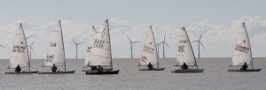 The fleet gets underway with the windfarm looking on