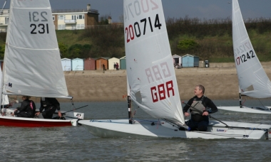 The start of the race and Paul Stanton, in his Laser, concentrates in overtaking Andy Dunnett and Nadia MacDonald in their RS200