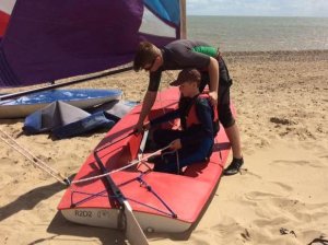 Qualified sail training member Elliot Berry shows Cadet Mac Symmonds the theory of sailing before he heads out onto the open sea