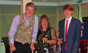 Time for a laugh, despite a leg injury, when Tom and Ed Philpot are presented with the 405 Class Points Trophies by Helen Swinbourne