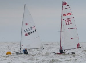 Andy Dunnett makes the buoy in his Laser, just ahead of of Rob Lockett in his Blaze