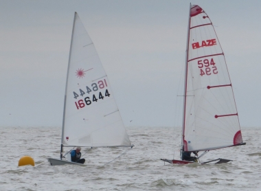 Andy Dunnett makes the buoy in his Laser, just ahead of of Rob Lockett in his Blaze